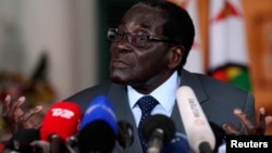 FILE: Zimbabwe's President Robert Mugabe addresses a media conference at State house in Harare, July 30, 2013.