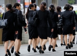 FILE - Female office workers wearing business clothes in Tokyo, Japan, June 4, 2019. (REUTERS/Kim Kyung-Hoon)