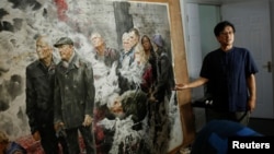 The head of the Mansudae Art Museum Ji Zhengtai talks about a painting by a North Korean artist in the studio of the gallery in the 798 art district in Beijing, China, September 20, 2017. (Reuters) 