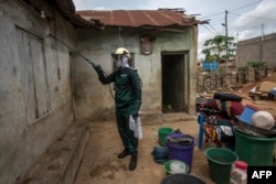 A worker of Anglogold Ashanti Malaria Ltd sprays the walls of a house with insecticide against mosquitos, May 2, 2018 in Adansi Domeabra, near Obuasi, Ashanti Region.