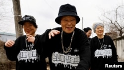 Park Jeom-sun, 81, the leader of the granny rap group "Suni and Seven Princesses", along with members Hong Sun-yeon, 79, and Jeong Du-i, 90, raps on the street in Chilgok, South Korea, February 6, 2024. (REUTERS/Kim Soo-hyeon)