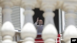 FILE - In this Sunday, June 7, 2020 file photo, Pope Francis delivers his blessing as he recites the Angelus noon prayer from the window of his studio overlooking St.Peter's Square, at the Vatican. (AP Photo/Andrew Medichini, File)