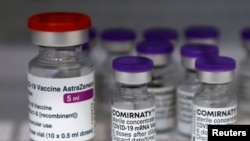 Vials of the AstraZeneca and Pfizer-BioNTech Comirnaty coronavirus disease (COVID-19) vaccines are pictured in a General practitioners practice in Berlin, Germany, April 10, 2021. 