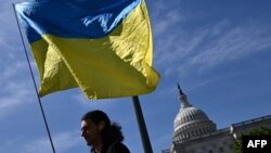 Activists wave the Ukrainian flag outside the US Capitol in Washington, DC, on April 23, 2024.