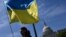 Activists wave the Ukrainian flag outside the US Capitol in Washington, DC, on April 23, 2024.