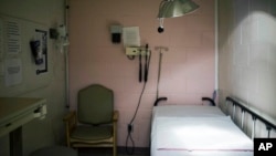 FILE - A hospital exam room is seen in Alabama on Thursday, July 30, 2015. (AP Photo/Brynn Anderson, File)