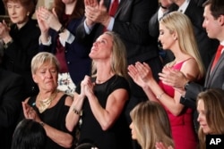 Carryn Owens, widow of Navy Seal William “Ryan” Owens, is applauded during President Trum's speech on February 28.