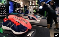 The word "Boston" is in the sole of this New Balance shoe on display at the storefront of the world headquarters of New Balance in Boston.