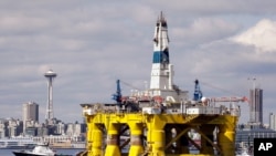 FILE - The oil drilling rig Polar Pioneer is towed toward a dock in Elliott Bay in Seattle, May 14, 2015. The rig was the first of two drilling rigs Royal Dutch Shell was outfitting for Arctic oil exploration. President Barack Obama has designated the bul
