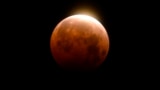 Light shines from a total lunar eclipse over Santa Monica Beach in Santa Monica, Calif., Wednesday, May 26, 2021. (AP Photo/Ringo H.W. Chiu)