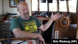  Fisherman Mike Hudson sits in the cabinet of his boat and talks about his most recent small catch of salmon at the Berkeley, Calif., Marina on Thursday, July 22, 2021.(AP Photo/Eric Risberg)