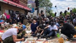 Terrence Floyd(C), the brother of George Floyd, an unarmed black man died May 25th in Minneapolis police custody, sits as people gather at the site of Floyd's death. June 1, 2020.