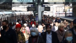 FILE - People walk along a platform after departing from a train at King's Cross Station, amid the COVID-19 outbreak in London, Britain, October 21, 2021.