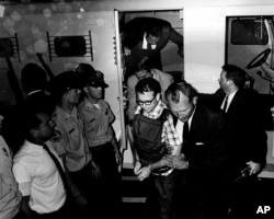 This 1968 photo released by the Shelby County Register's office on March 31, 2011 shows James Earl Ray being transported in Memphis, Tennessee. (REUTERS/Shelby County Register of Deeds)