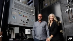 The Skysource/Skywater Alliance co-founders David Hertz, left, and his wife Laura Doss-Hertz pose for a portrait next to their invention Wednesday, Oct. 24, 2018, in Los Angeles. (AP Photo/Marcio Jose Sanchez)