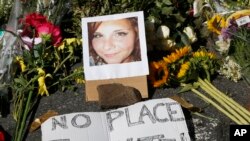 A makeshift memorial of flowers and a photo of victim, Heather Heyer, sits in Charlottesville, Va., Aug. 13, 2017. Heyer died when a car rammed into a group of people who were protesting the presence of white supremacists in the city.