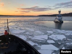 U.S. Coast Guard Cutter Penobscot Bay helps break free tug Stephanie Dann from the ice on the Hudson River near Kingston, New York, U.S., January 2, 2018. Picture taken on January 2, 2018. U.S. Coast Guard photo/Handout via REUTERS