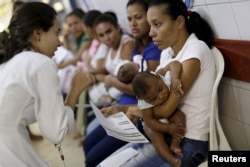 Mothers with their children, who have microcephaly, await medical care at the Hospital Oswaldo Cruz, in Recife, Brazil, Jan. 26, 2016.