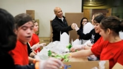 Democratic presidential candidate Sen. Cory Booker, center, D-N.J., tours the Three Square food bank Thursday, Dec. 19, 2019, in Las Vegas. (AP Photo/John Locher)