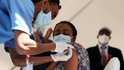 A woman receives the AstraZeneca/Oxford vaccine under the COVAX program against COVID-19 at the Eka Kotebe General Hospital in Addis Ababa, Ethiopia March 13, 2021. REUTERS/Tiksa Negeri