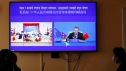 Nepalese government officers watch a live telecast of a joint announcement on the height of Mount Everest, in Kathmandu, Nepal, Tuesday, Dec. 8, 2020. China and Nepal have jointly announced on Tuesday, Dec. 8, 2020, a new height for Mount Everest, ending