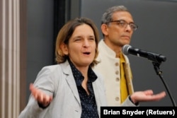 FILE - Abhijit Banerjee and Esther Duflo, two of the three winners of the 2019 Nobel Prize in Economics, speak at news conference at the Massachusetts Institute of Technology (MIT) in Cambridge, Massachusetts, U.S., October 14, 2019. (REUTERS/Brian Snyder/File Photo)