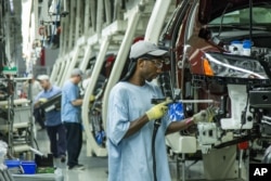 Factory work is often scheduled in shifts. In this June 2013 photo, workers assemble Volkswagen cars at the German automaker's factory in the U.S. state of Tennessee. (FILE PHOTO)
