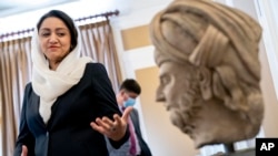 Afghan Ambassador to the U.S. Roya Rahmani, accompanied by embassy staff, speaks as she gives the Associated Press a tour at the Afghanistan Embassy in Washington, Wednesday, April 21, 2021.