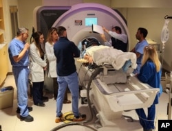 In this photo provided by the WVU Rockefeller Neuroscience Institute, an Alzheimer’s patient undergoes focused ultrasound treatment with the WVU RNI team in Morgantown, W.Va., on Oct. 17, 2023. (Victor Finomore/WVU Rockefeller Neuroscience Institute via AP)