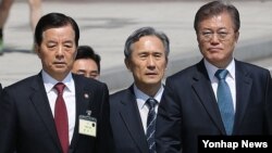 South Korean President Moon Jae-in (right) appears with former presidential security adviser Kim Kwan-jin (center) and defense minister Han Min Goo (right). Moon called on North Korea to stop "provocations" with its missile and nuclear program. He also moved to delay deployment of the American anti-missile system known as THAAD.