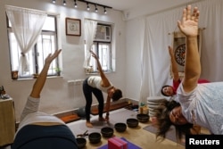 FILE - Young Hong Kongers wear workout clothes during a meditation session on September 2022. (REUTERS/Tyrone Siu)