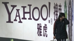 资料照片：一名女子在北京地铁里走过雅虎广告牌。(2006年3月17日)