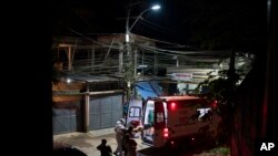 Mobile Emergency Care Service (SAMU) workers carry an elderly COVID-19 patient to an ambulance in Duque de Caxias, Rio de Janeiro state, Brazil, Wednesday, April 7, 2021. (AP Photo/Felipe Dana)