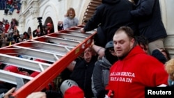 Pro-Trump protesters storm into the U.S. Capitol during clashes with police, during a rally to contest the certification of the 2020 U.S. presidential election results.