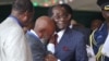 FILE An unidentified man who was in jail with Zimbabwean President Robert Mugabe during the liberation struggle, cries, as he greets him, during celebrations to mark his 92nd Birthday celebrations in Masvingo about 300 kilometres south of Harare, Saturday, Feb, 27, 2016. (AP Photo/Tsvangirayi Mukwazhi)