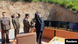 North Korean leader Kim Jong Un looks on during the test-launch of the intercontinental ballistic missile Hwasong-14 in this undated photo released by North Korea's Korean Central News Agency (KCNA) in Pyongyang July 5, 2017. KCNA/via REUTERS 