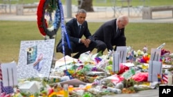 President Barack Obama and Vice President Joe Biden visit a memorial to the victims of the Pulse nightclub shooting, Thursday, June 16, 2016 in Orlando, Fla. Offering sympathy but no easy answers, Obama came to Orlando to try to console those mourning the deadliest shooting in modern U.S history. (AP Photo/Pablo Martinez Monsivais)