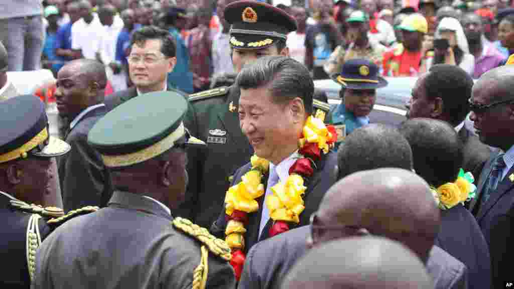 Chinese President Xi Jinping, centre, is welcomed upon his arrival in Harare, Zimbabwe, Tuesday, Dec. 1.2015. Jinping is in Zimbabwe for a two day State visit during which he is set to sign some bilateral agreements aimed at strengthening relationships between the two countries.