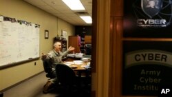 Colonel Gregory Conti, military intelligence director of the Cyber Research Center at the United States Military Academy, sits in his office in West Point, N.Y., Wednesday, April 9, 2014. A team of Conti's West Point cadets is fending off cyber attacks this week as part of an exercise involving all the service academies. The annual Cyber Defense Exercise requires teams from the five service academies to create computer networks that can withstand attacks from the National Security Agency and the Department of Defense. (AP Photo/Mel Evans)