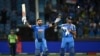 India's Virat Kohli (L) standing next to his teammate Axar Patel celebrates after scoring a century (100 runs) and their team's win at the end of the ICC Champions Trophy one-day international (ODI) cricket match between Pakistan and India at the Dubai In