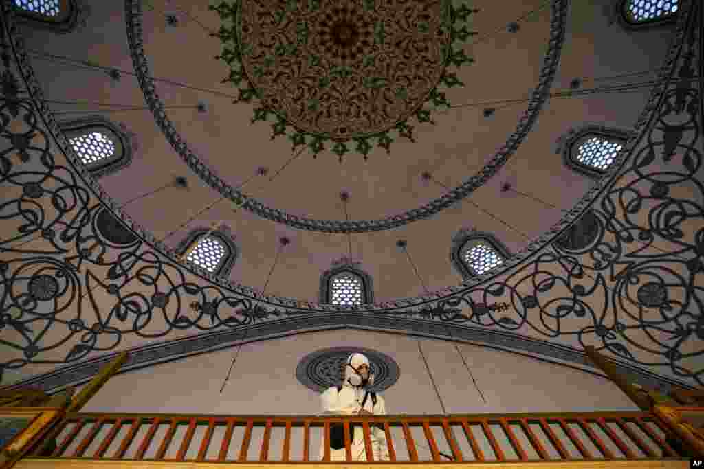 A disinfection team disinfects the premises of the grand mosque in capital Pristina, as Kosovo&#39;s mosques reopened after more than two months of the virus lockdown.