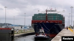 REUTERS: A gate is opening to a Chinese COSCO container vessel navigating through the Agua Clara locks during a ceremonial pass through the newly expanded Panama Canal on June 26, 2016