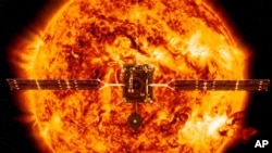 This illustration, made available by NASA, shows the Solar Orbiter satellite in front of the Sun. (ESA/ATG medialab, NASA/SDO/P. Testa (CfA) via AP)