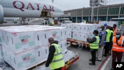 FILE - Officials receive boxes of Moderna coronavirus vaccine at the airport in Nairobi, Kenya, Sept. 6, 2021. 