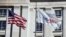 FILE PHOTO: An American flag and USAID flag fly outside the USAID building in Washington