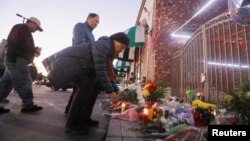 民众在加州蒙特利帕克市发生枪击案的舞厅外摆放鲜花致意（2023年1月23日）