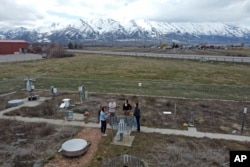 Climate Data Analyst Casey Olson, center left, of Utah State University stands with students during a tour of the climate reference station on April 1, 2024, in Logan, Utah. (AP Photo/Rick Bowmer)