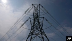 FILE - An electricity pylon is seen in Lydd, southern England, Monday, Aug. 15, 2022. (AP Photo/Frank Augstein, file)