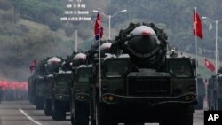 Des missiles nord-coréens défilent sur les camions font son chemin lors d'une parade militaire marquant le 65e anniversaire du Parti des travailleurs, au pouvoir, à Pyongyang, Corée du Nord, 10 octobre 2010. (AP Photo / Vincent Yu)