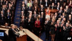 Republicans lawmakers applaud as President Donald Trump speaks to a joint session of Congress in Washington, Tuesday, Feb. 28, 2017. (AP Photo/J. Scott Applewhite)